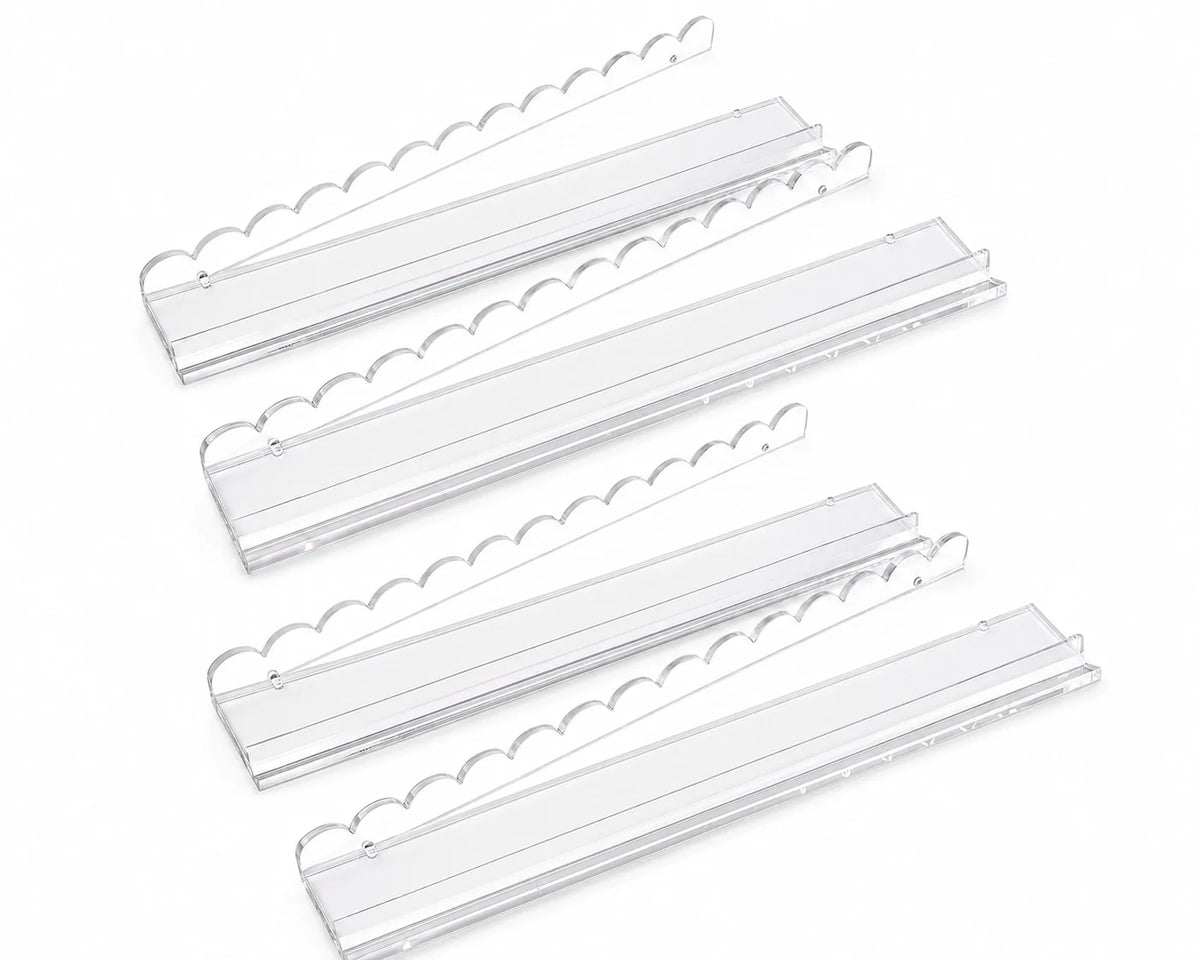 Clear American Mahjong racks and tile pushers on a white background