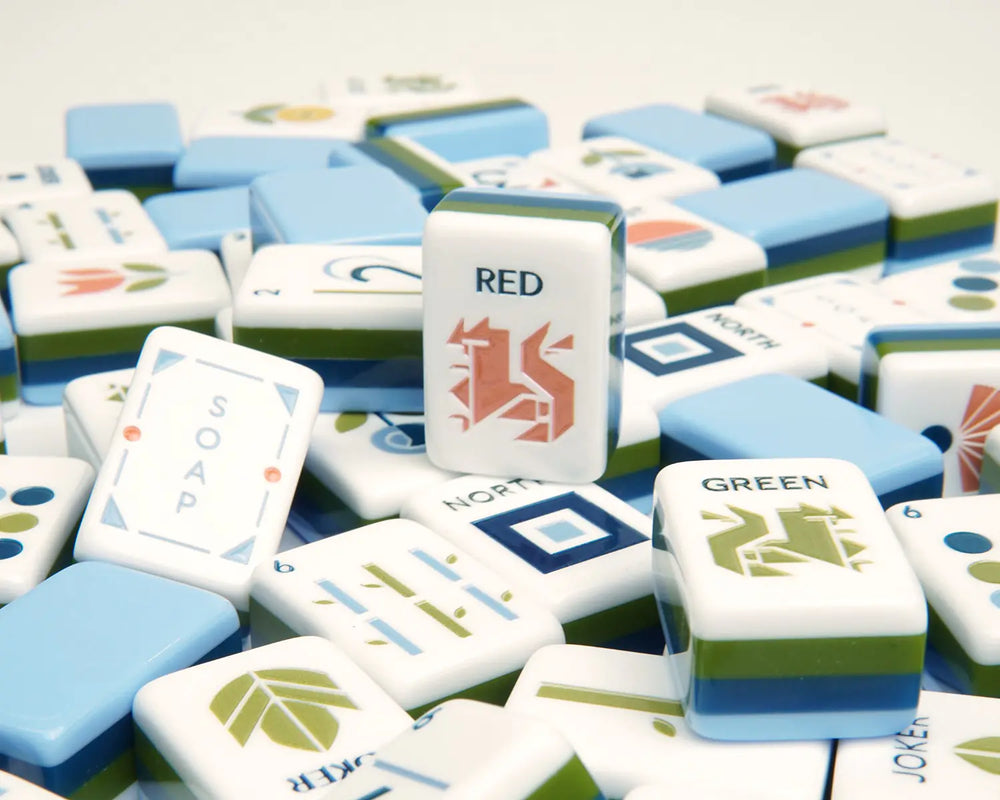 Blooming Geometry American Mahjong tiles scattered with blue backs and geometric faces