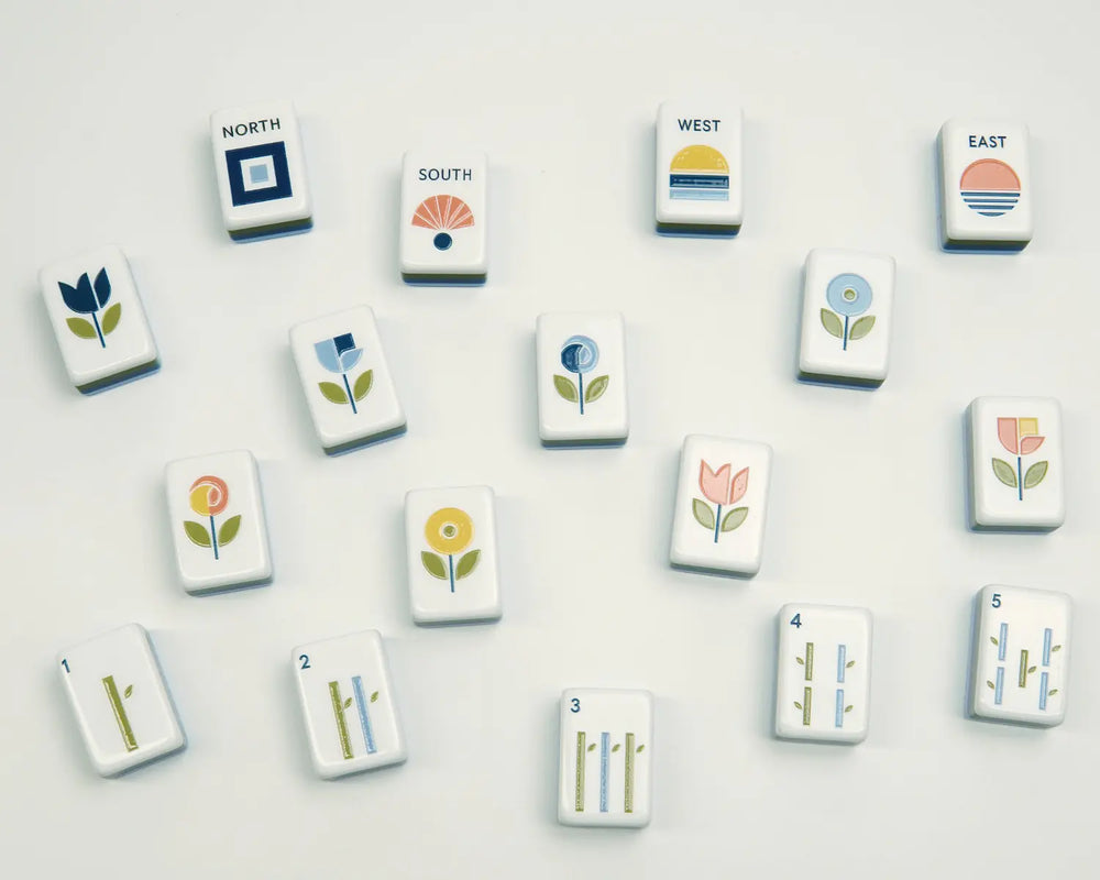 Blooming Geometry wind, flower and Bam tiles arranged across a warm ivory background