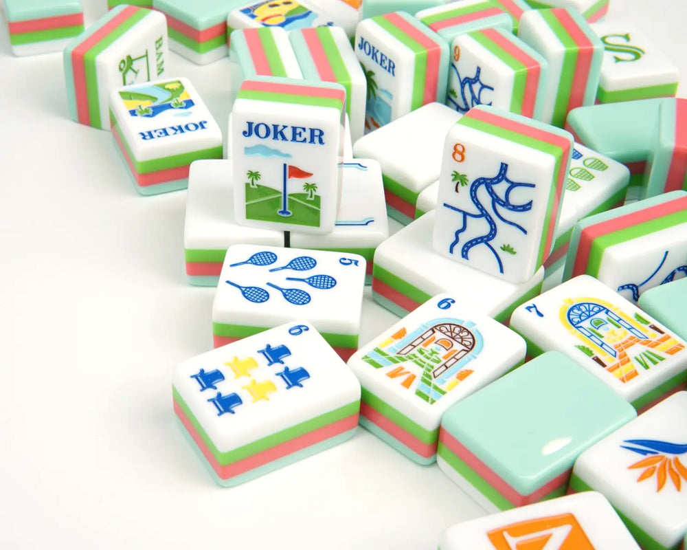 Scattered Blue Manor Mahjong tiles showing resort artwork and layered backs