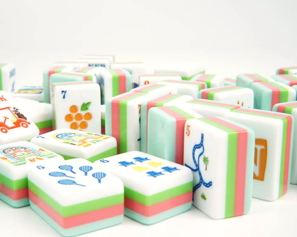 Blue Manor tile faces and layered edges arranged across a warm ivory background