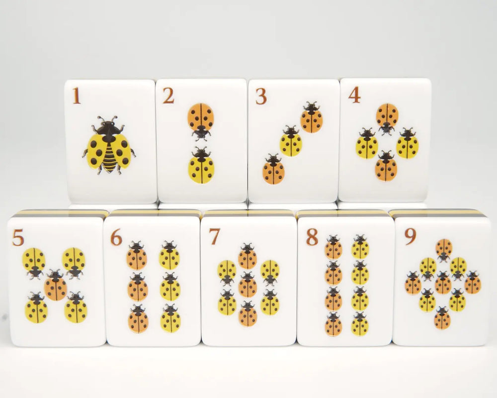 Close-up of Golden Wilds ladybug Dot tiles one through nine