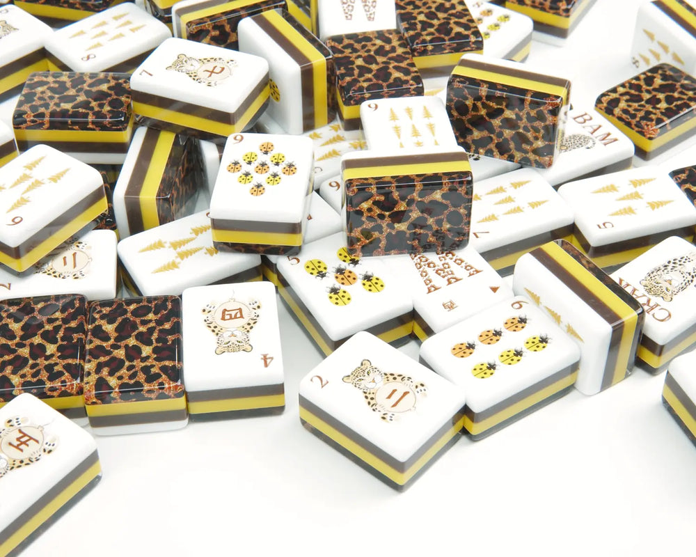 Golden Wilds leopard-back tiles scattered with ladybug and golden tree faces