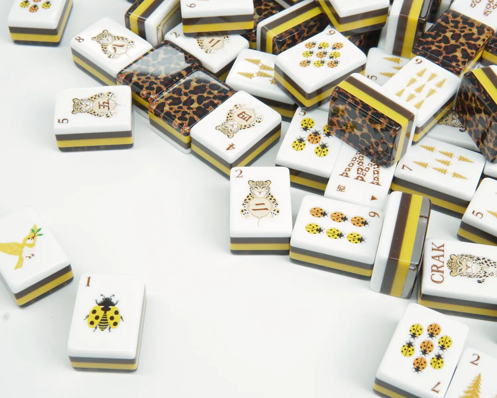 Golden Wilds Mahjong tiles scattered across a light tabletop with leopard backs visible