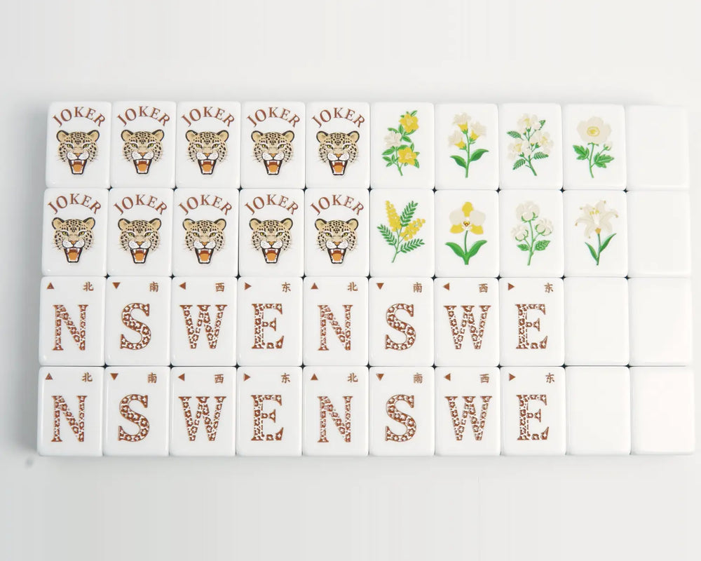 Golden Wilds Joker, flower, wind and blank Mahjong tiles arranged in four rows