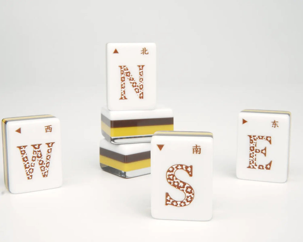 Golden Wilds cardinal Wind tiles with leopard-patterned letters