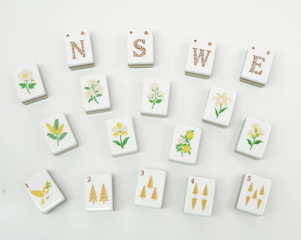 Golden Wilds wind, flower and golden tree Bam tiles arranged loosely on a light surface