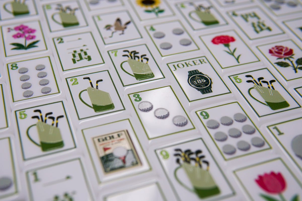 Original Moira Fairway Mahjong photograph showing golf bags, golf balls, flowers, and a watch Joker on white and green acrylic tiles